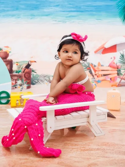 A little mermaid relaxes on her beach chair in this creative and fun-filled first birthday setup.