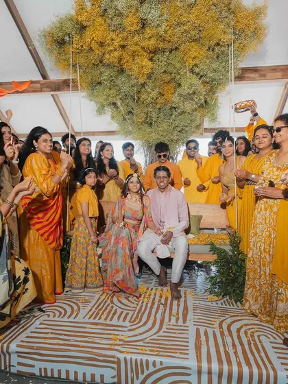 For a Bali-themed Haldi, we created this incredible setup featuring a giant tree made of baby's breath and a large swing for the couple. The open design offered breathtaking views of Banasura lake, just as the bride envisioned.