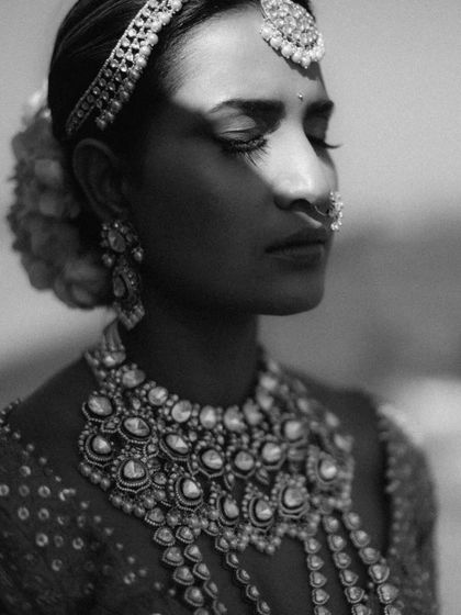 A dramatic black and white portrait with a strong play of light and shadow. This artistic approach creates a powerful and memorable image.