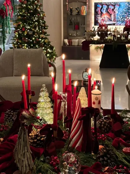 The festive decor and ambiance of a Christmas dinner we catered, with red candles and holiday-themed decorations.