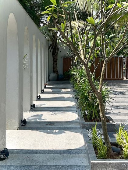 A perspective view of the arched walkway, showing how the repeating forms create a sense of depth and movement, guiding the eye and the visitor through the space.