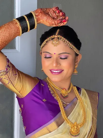 This pose showcases the intricate henna design on her hands, along with her flawless makeup and traditional jewellery.