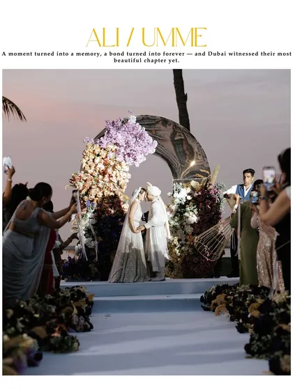 A magazine-style shot of the couple's first kiss as husband and wife. This captures the epic scale of their Dubai wedding, with the sunset and floral arch creating a breathtaking scene.