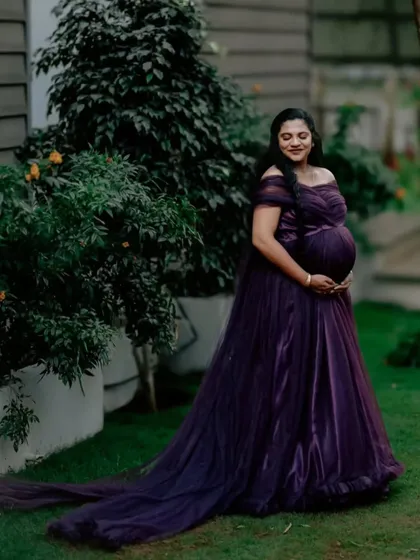 For all the moms-to-be, I design gowns that celebrate you. This deep purple off-shoulder maternity gown features a delicate tulle fabric and a long trail, creating a look of pure elegance for your maternity photoshoot.