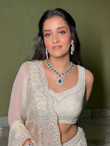 This portrait showcases the complete look: a stunning white lehenga, emerald jewelry, and my signature soft glam makeup. The result is a look that is sophisticated, elegant, and effortlessly beautiful.