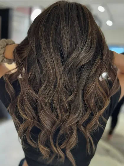 Here, we transitioned from a warmer color to this cool beige balayage. The new tones and fresh haircut work together to create a sophisticated and modern look.