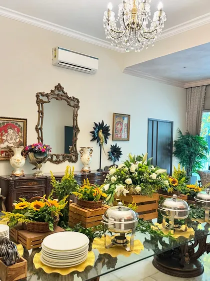 Our catering adapts to any setting, including this elegant indoor dining room. We set up a full buffet with hot dishes in chafing pans, complemented by floral arrangements that match the home's sophisticated decor.