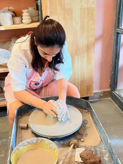 Getting the feel for the clay. A student centers a ball of clay, the fundamental first step of wheel-throwing.
