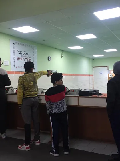 Young shooters learning the fundamentals of pistol shooting at the range.