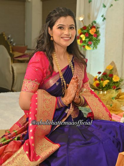 Aishwarya seated during her engagement puja. The entire look, from the makeup to the saree draping, is designed for both beauty and comfort during long ceremonies.