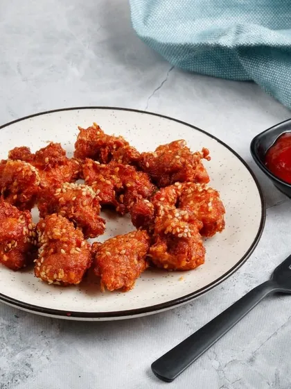 A plate of our crunchy Popcorn Chicken, perfect for sharing or as a snack. Each piece is seasoned and fried for maximum flavour.