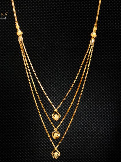 This triple-strand gold necklace features small, dangling pendants, creating a layered look in a single piece. It's an example of our lightweight designs that are both elegant and easy to wear.