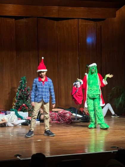 The Grinch makes a dramatic appearance in our holiday show, a testament to how our students embrace bold characters and command the stage.