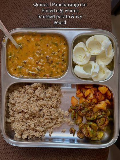 This plate combines quinoa with panchrangi dal, boiled egg whites, and sautéed potato and ivy gourd.