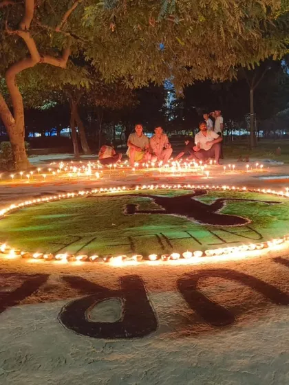 A beautiful, warm shot of the lit-up long jumper rangoli.