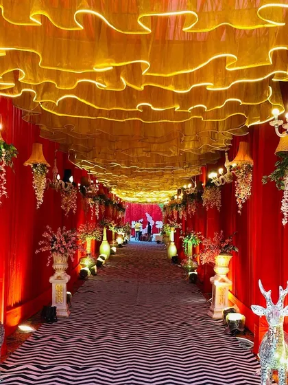 Another view of the red and gold walkway, featuring sparkling deer props that add a whimsical touch to the luxurious decor.