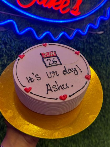 A special cake for a special day, with a calendar marking June 26th. The simple design with red hearts is a personal and heartfelt way to celebrate someone's birthday.