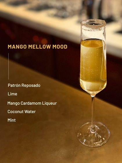 The Mango Mellow Mood is a smooth, tropical delight. Patrón Reposado is mixed with a mango cardamom liqueur, coconut water, and mint for a refreshing sip.