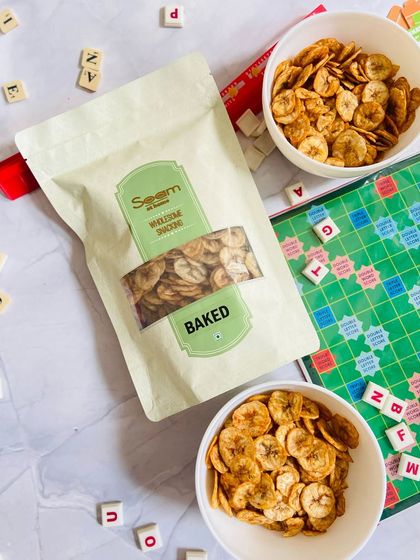 Another angle of the game night setup, with my baked banana chips taking center stage next to a Scrabble board. It's the ideal snack for fun and games.