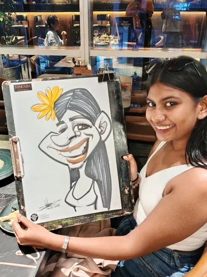 This guest's caricature includes a flower in her hair, adding a touch of whimsy to the portrait.