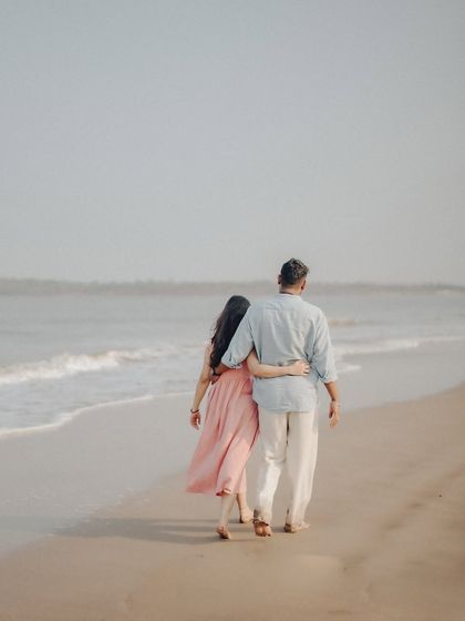 A shot from behind as Anushka and Manu walk along the beach, arm in arm. This perspective creates a sense of journey and togetherness.