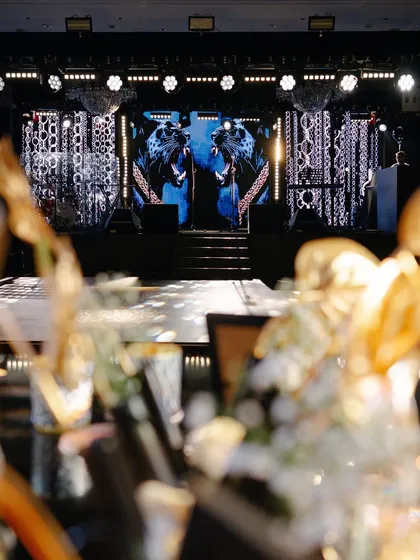 A view of the high-energy stage from a guest's perspective, with the dramatic lighting and LED visuals creating an immersive concert-like atmosphere for the performances.