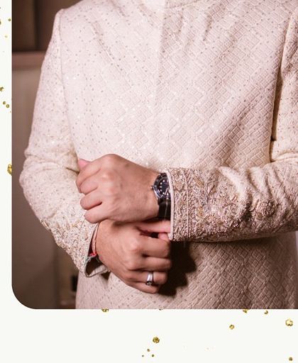 It's all in the details. A close-up of the groom's elegant sherwani and accessories, perfectly complementing the wedding's theme.