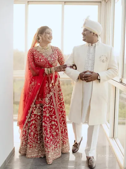 A candid moment of joy between the bride and groom. Her makeup was designed to last through all the smiles, tears, and celebrations of her wedding day, looking flawless from every angle.