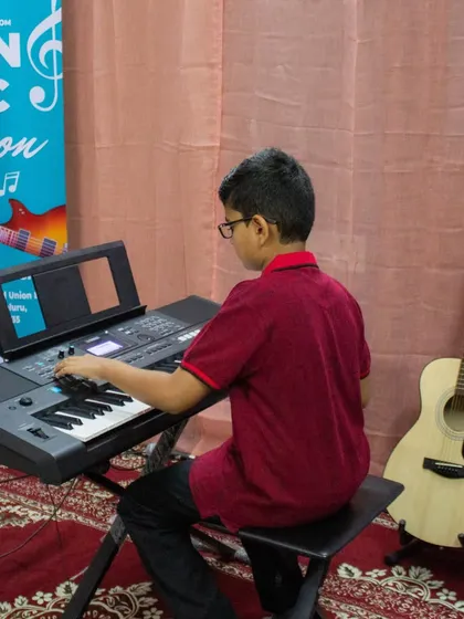 A photo of a student playing the keyboard at our Sarjapur open mic.