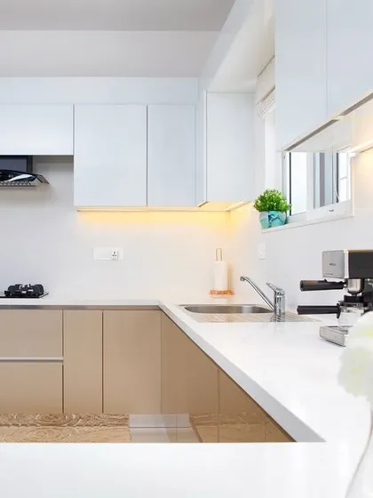 There's a certain magic in a kitchen that glows. The combination of warm beige and crisp white handleless cabinets feels both clean and cozy. I use under-cabinet LED lighting not just for task illumination, but to create a soft ambiance for those quiet morning coffees or late-night chats.