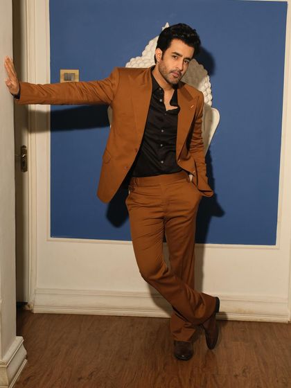 A full-length shot of Satyajeet Dubey, redefining sophistication in our brown formal suit, perfectly complemented by matching trousers.