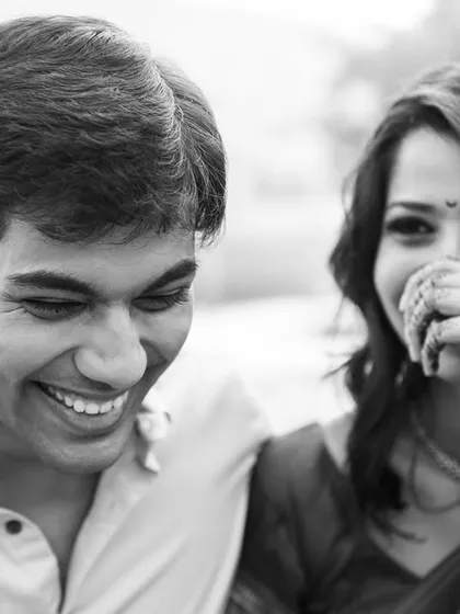 A stolen moment of shy laughter. We often use black and white to emphasize the emotion and connection, stripping away all distractions.