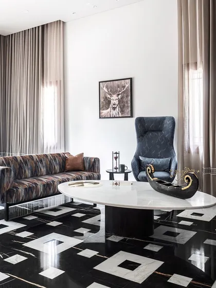 For the large office space, we shifted to a contemporary yet timeless aesthetic. Exotic black and white marble flooring in an overlapping pattern and plush, modern furniture create an elegance befitting the many different people this space would host.