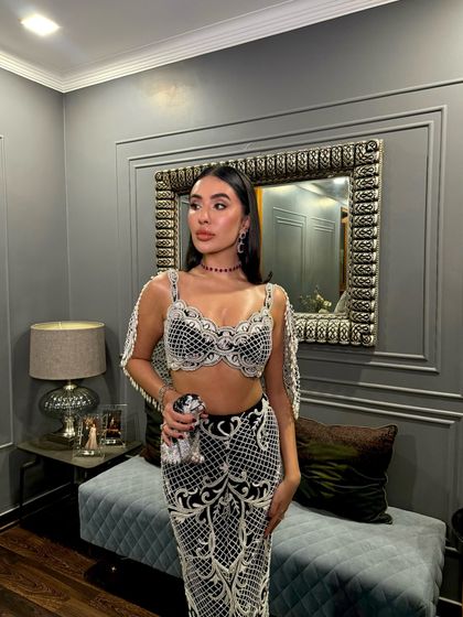 A style moment that’s nothing short of breathtaking, featuring the charcoal black pearl-embellished set.