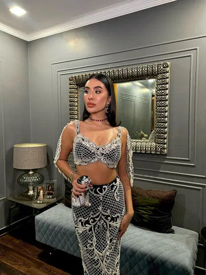 A style moment that’s nothing short of breathtaking, featuring the charcoal black pearl-embellished set.