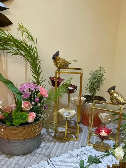 Nature-inspired decor featuring a fresh floral arrangement alongside my golden bird candle stands. This composition blends the beauty of flowers with the elegance of metallic accents for a serene and stylish corner.