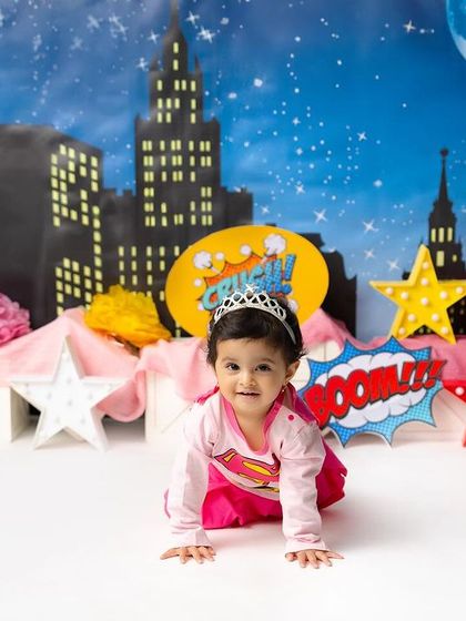 Here comes Wonder Woman! This little superhero is crawling into action in front of a dynamic city backdrop, ready to save the day.