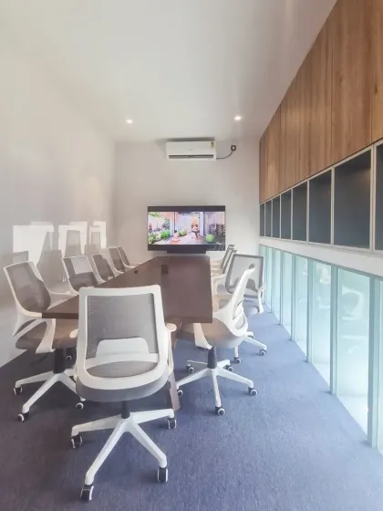 Inside the marketing office, this conference room is designed for focus and clarity. A long window provides natural light and a constant visual connection to the green landscape just outside.