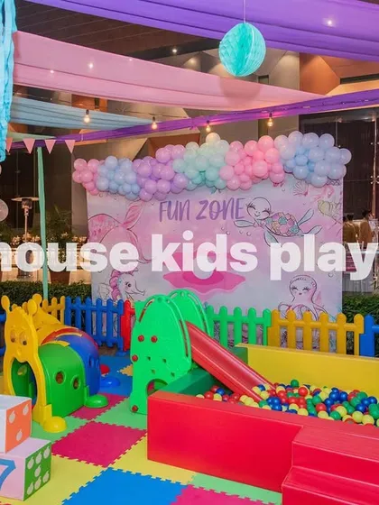 The complete indoor rainbow play area, ready for party guests. The setup includes giant foam blocks, a slide, and a ball pit.