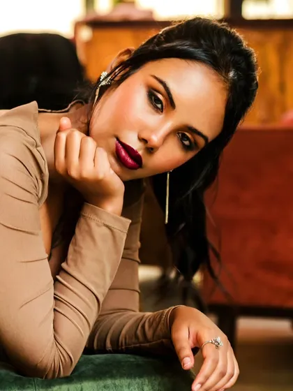 A classic full-glam makeup application, featuring a bold, matte burgundy lip and a warm smokey eye. This is a go-to look for evening events, red carpets, and shoots requiring a strong, confident presence.