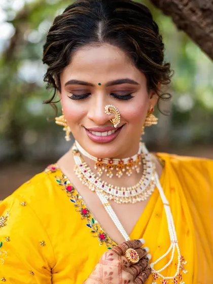 A close-up on the eye makeup and the intricate *nath*. I used soft brown and gold tones to make her eyes pop while keeping the look traditionally elegant.