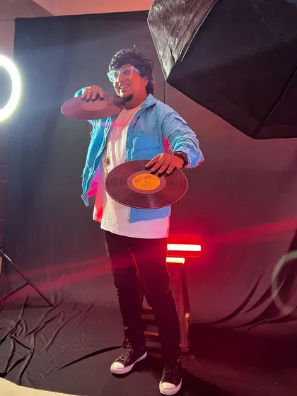 A behind-the-scenes look at a photoshoot with vinyl records and studio lighting. This captures my dedication to the craft and my dream of chasing the light.