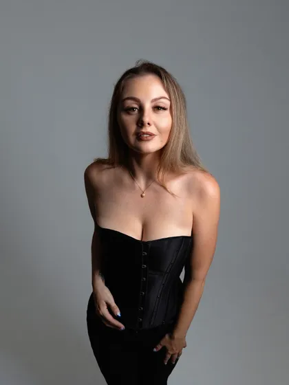 A similar pose from the same photoshoot, with slightly different lighting and expression.