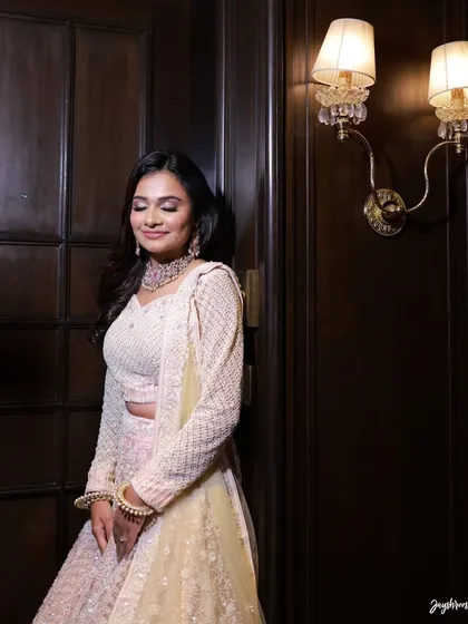 A full-length portrait of the bride, her pastel lehenga looking ethereal and elegant.