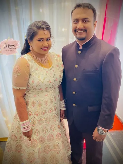 A happy couple at their reception. I provided a complete makeover for both the bride and groom, ensuring their looks were coordinated and they both felt their absolute best for the evening's festivities.