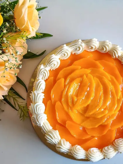 I love working with seasonal fruits, and this fresh mango cake is a favorite. Here, I've carefully arranged thin slices of Alphonso mango to form a beautiful rose, turning a simple cake into a piece of edible art.