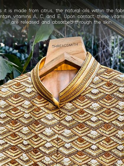 A close-up on the collar of our orange fiber garment. The natural oils in the fabric, containing vitamins A, C, and E, are released upon contact with the skin.