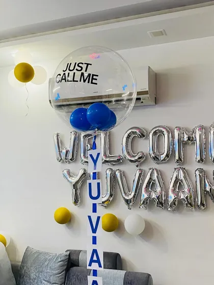 A close-up of the "WELCOME YUVAAN" foil balloons and the custom name reveal balloon for a personalized touch.