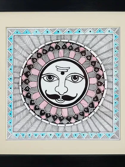 The sun god, Surya, is depicted in the classic Madhubani style by artist Lakshit Mukhiya. The face is surrounded by intricate patterns, representing the sun's powerful rays.