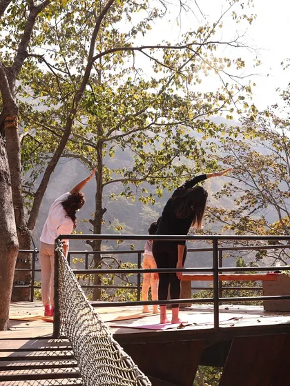 Prana is the vital life force. In our retreats, we practice asana and pranayama in beautiful natural settings, like this treehouse deck in Rishikesh, to ensure the smooth movement of prana throughout our entire system.